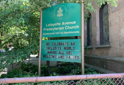 Sign in front of church with the phrase We celebrate an inclusive world where all are welcome and valued.