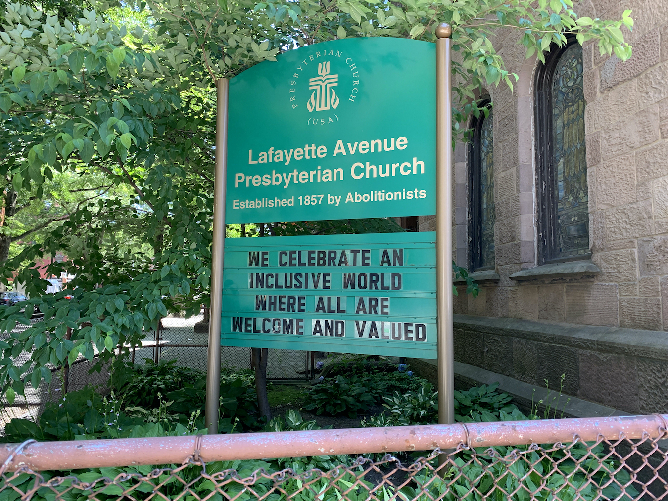Sign in front of church with the phrase We celebrate an inclusive world where all are welcome and valued.
