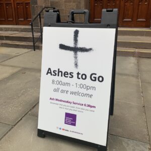 Sign in front of church building with text "Ashes to Go"